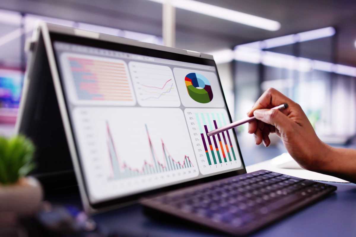 woman analyzing financial data on laptop